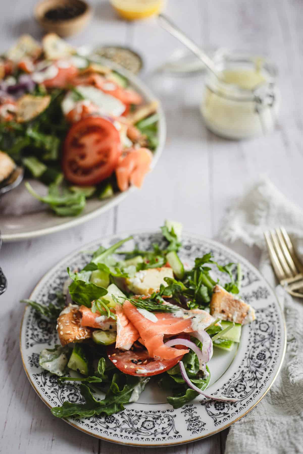 salad on plate with main portion and dressing