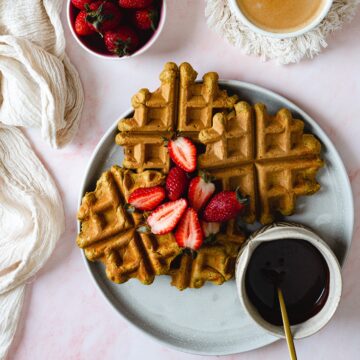 waffles on a plate with chocolate sauce and strawberries  Apple olive oil cake Protein pumpkin waffles with protein chocolate sauce THUMBNAIL 360x360