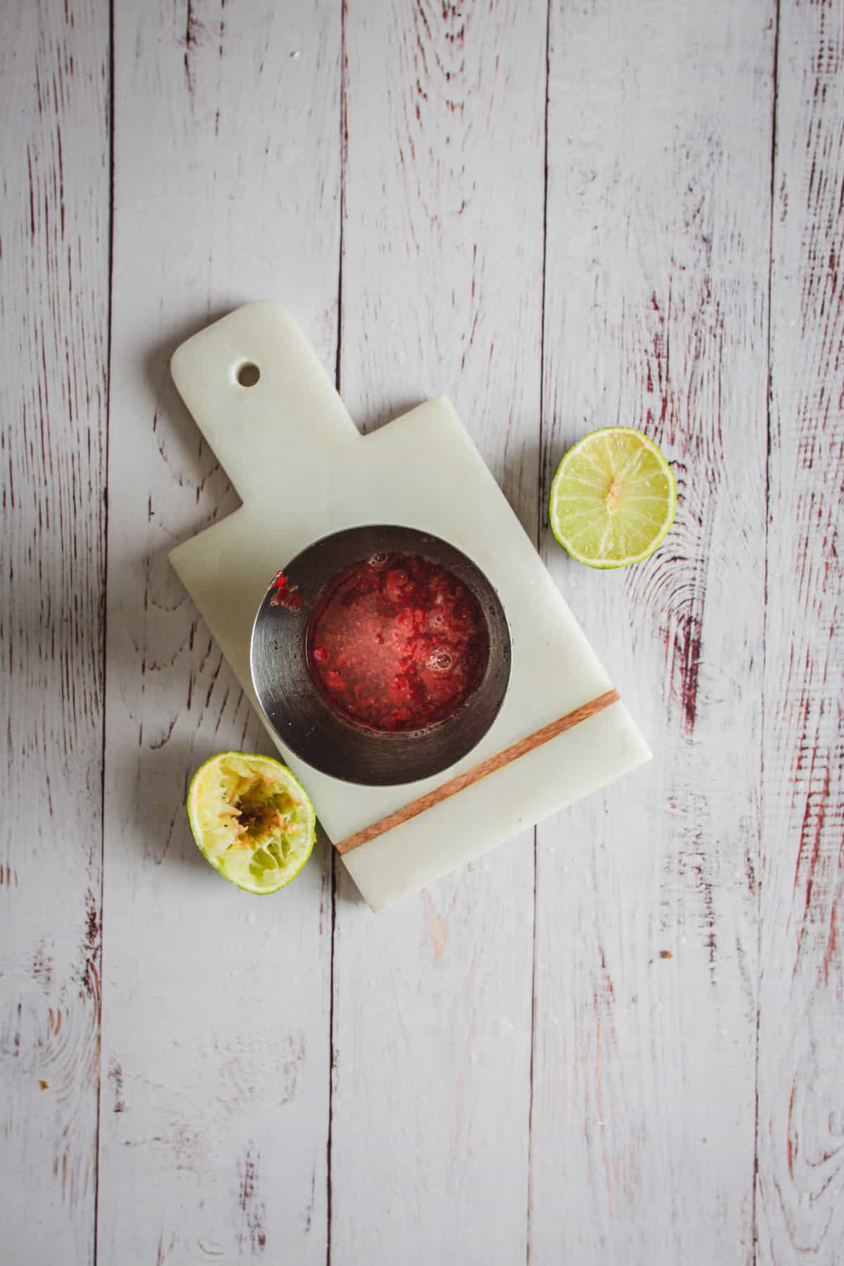 strawberry puree in shaker with limes