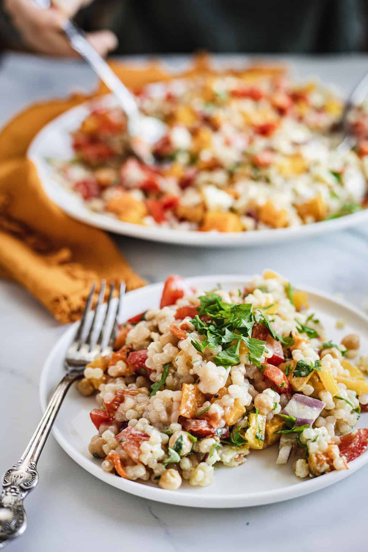 salad serving with fork and more salad in background