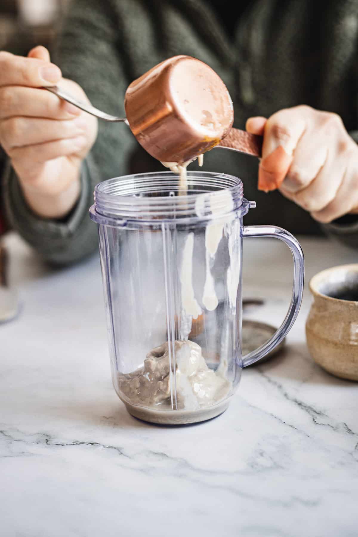 adding tahini to blender