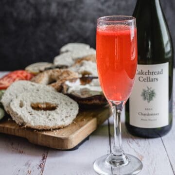 pink cocktail in glass with bottle