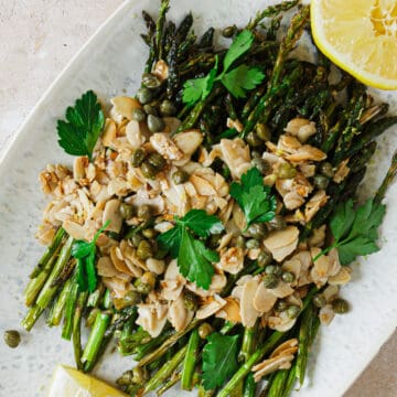 close up on air fried asparagus with almonds and parsley