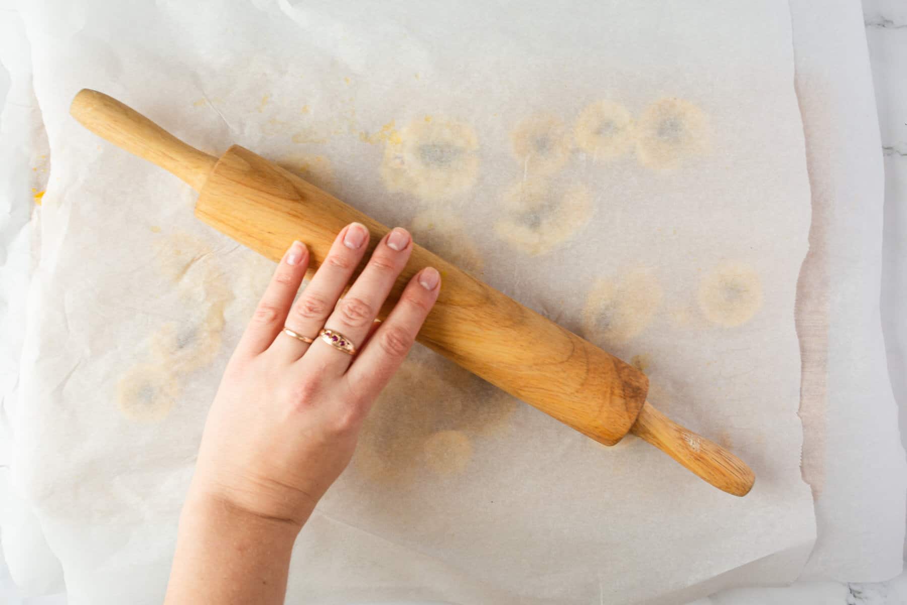 flattening plantain slices on baking sheet