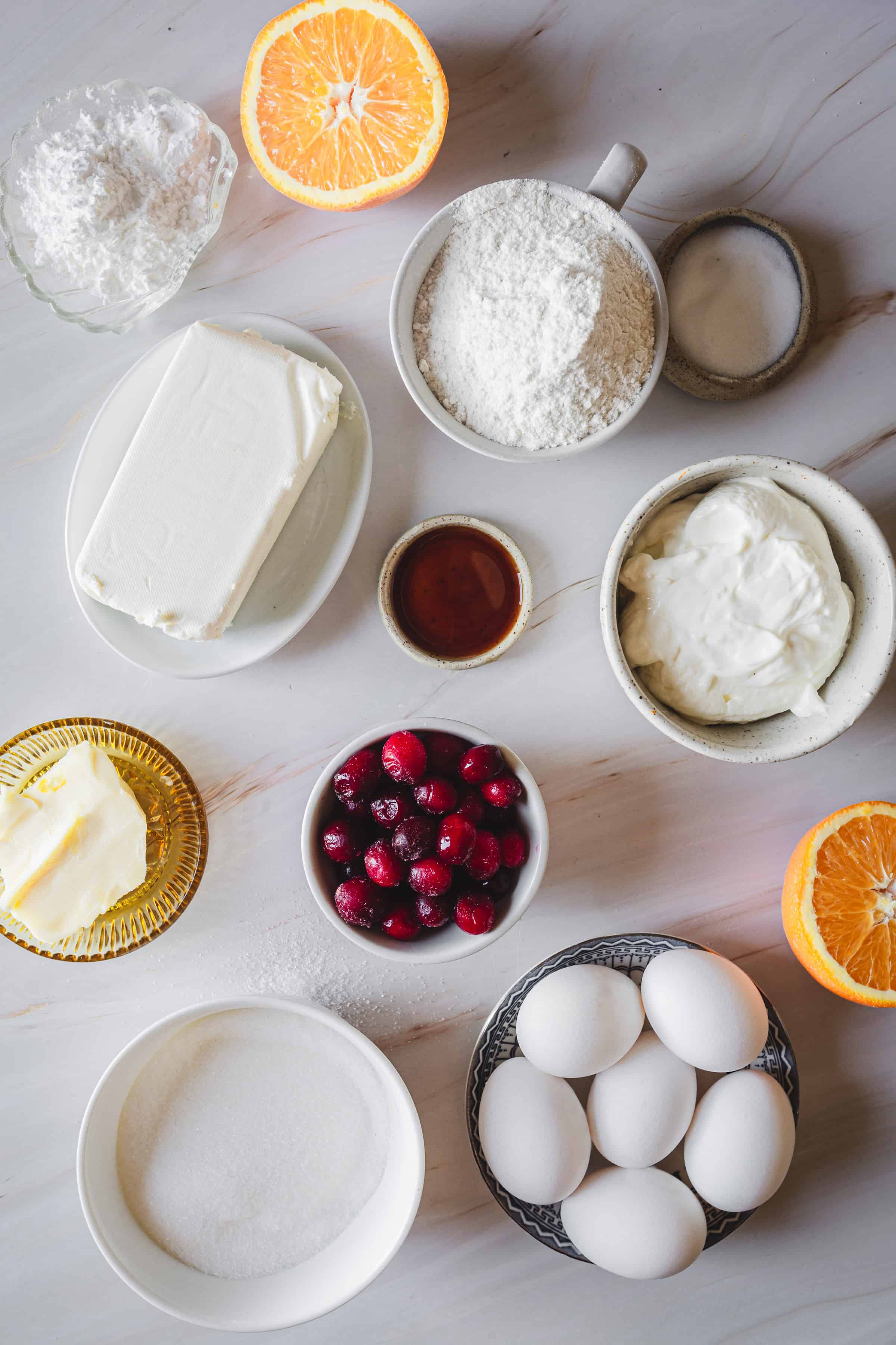 cranberries, eggs, cream cheese, and other ingredients on a table