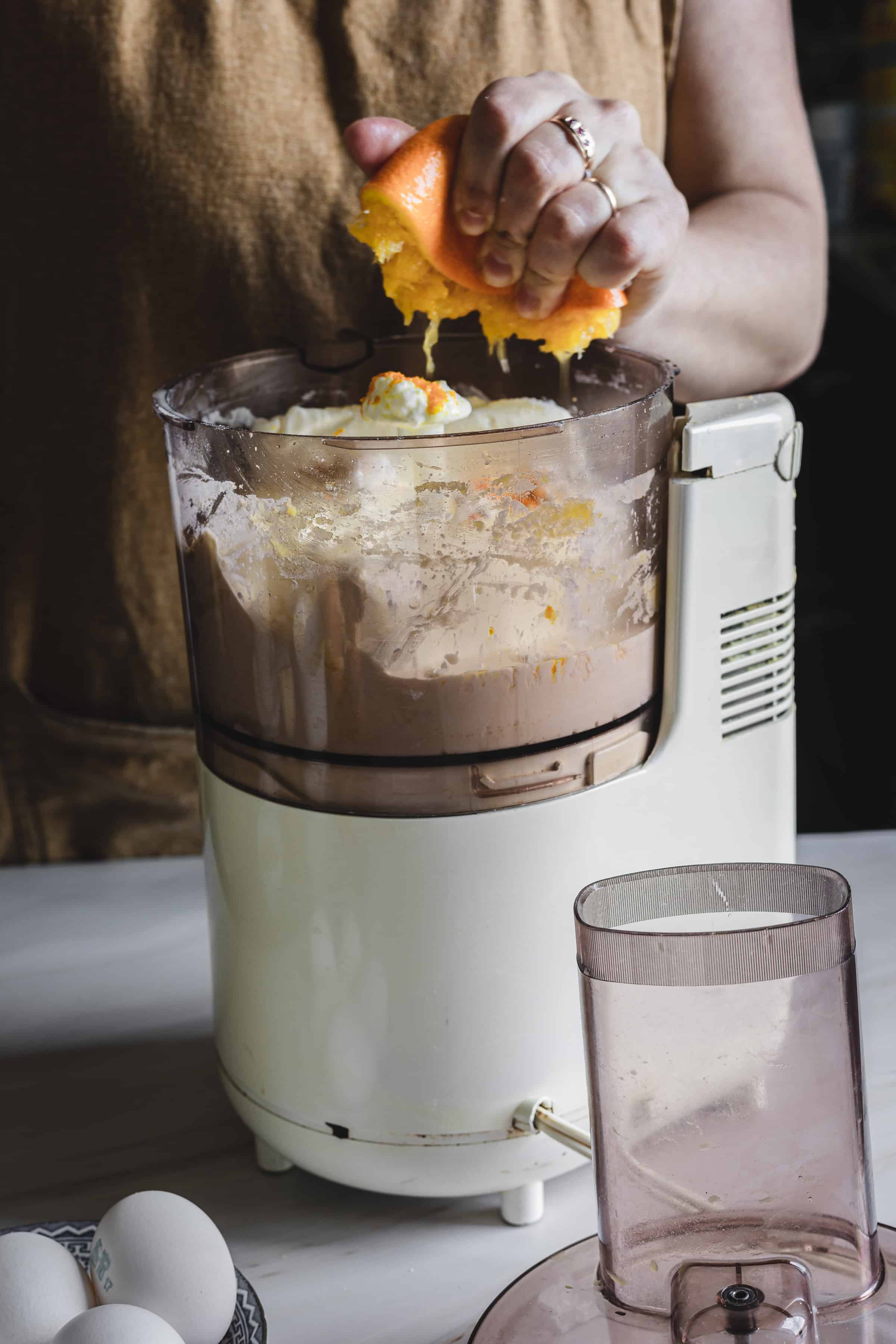 squeezing an orange into the food processor