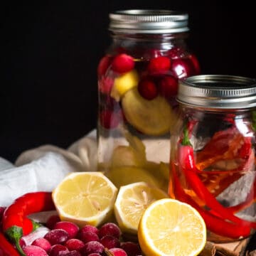 Two different vodka infusion jars with ingredients