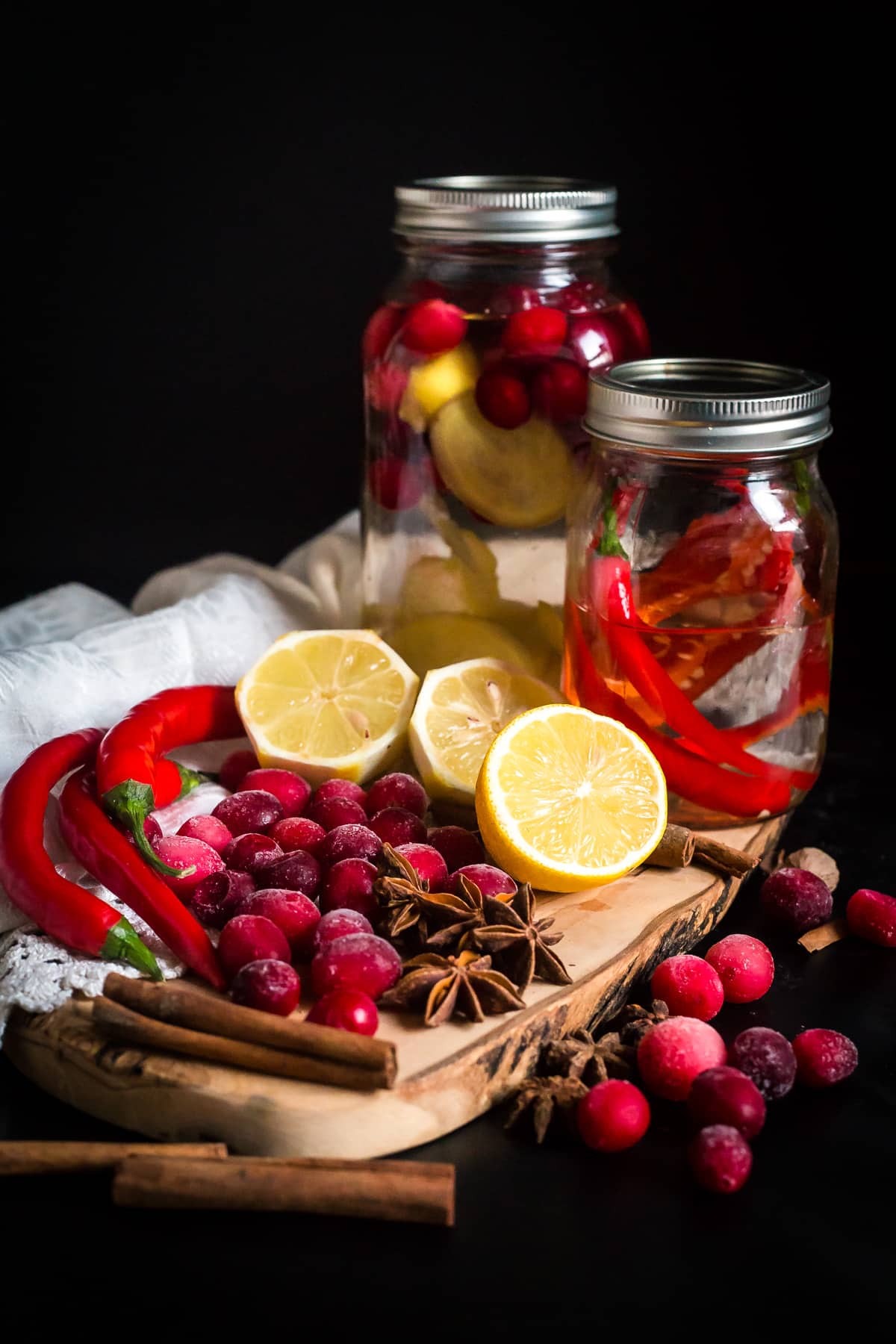 Two different vodka infusion jars with ingredients