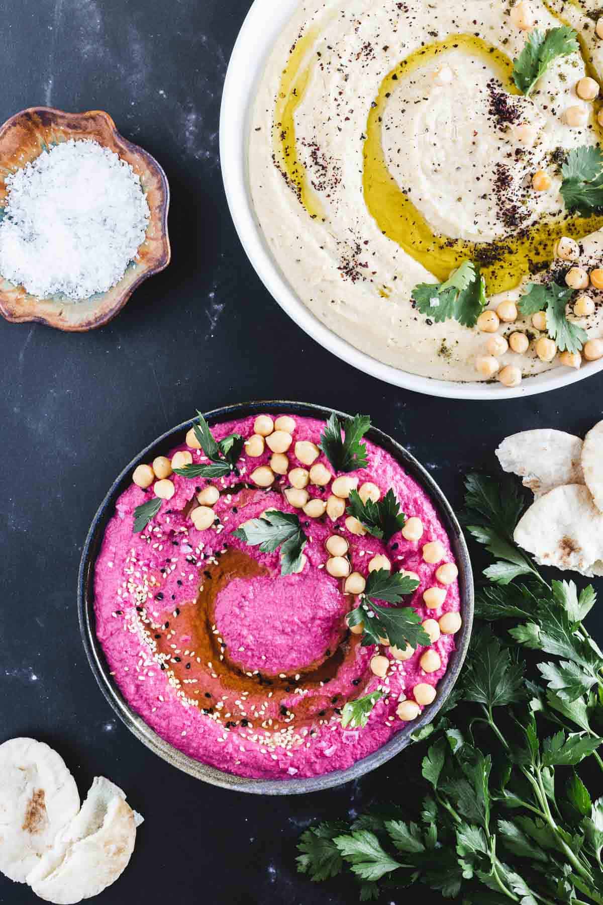 Seasoned and garnished beet hummus in a bowl.