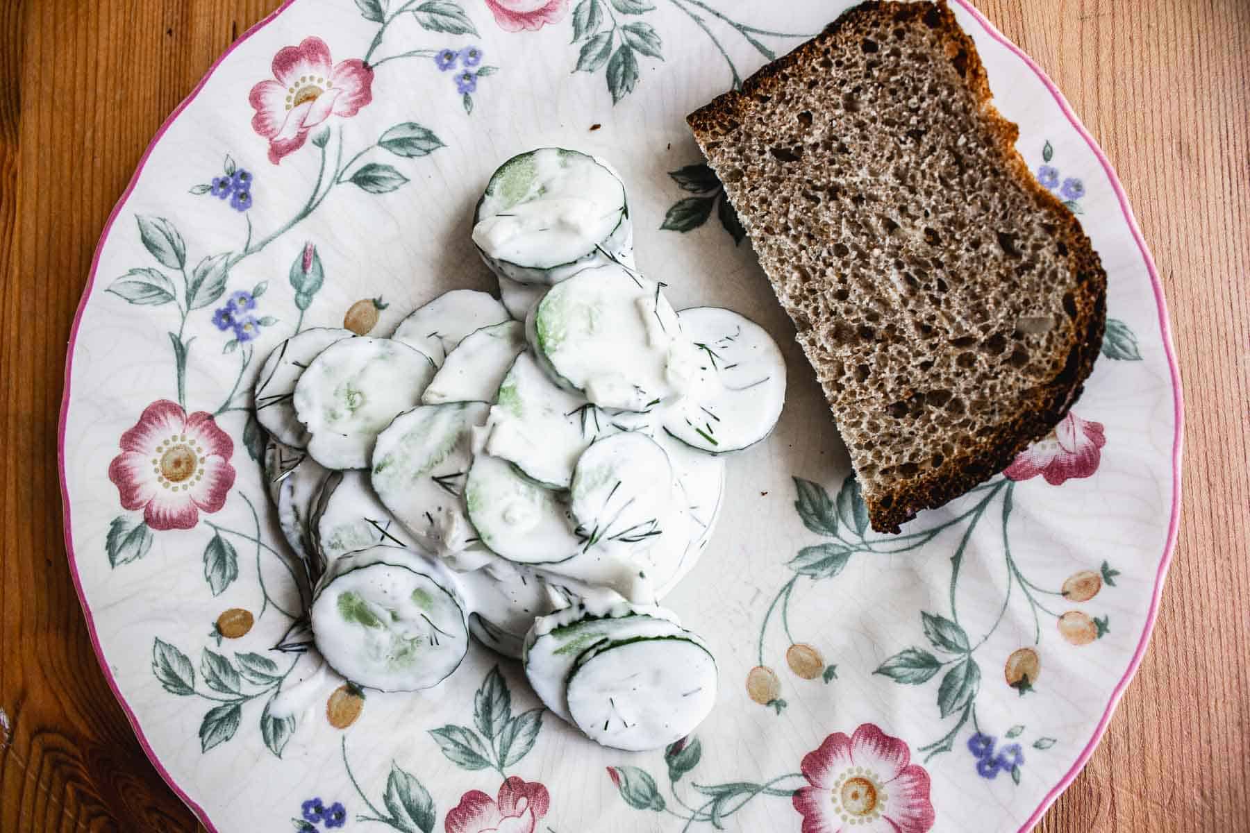 A serving of cucumber salad with bread.