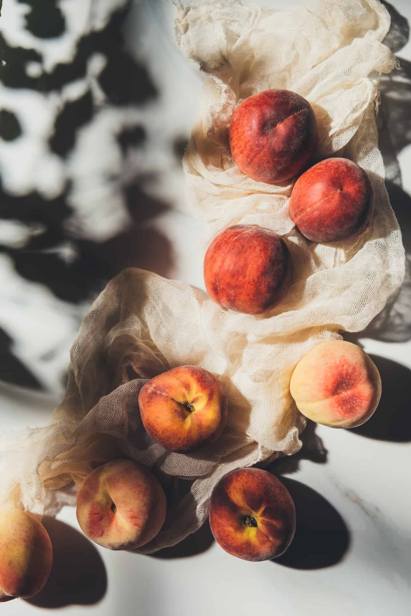 How to freeze peaches on a white cloth on a table.
