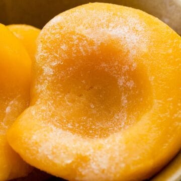 Learn how to freeze sliced peaches in a bowl with sugar.