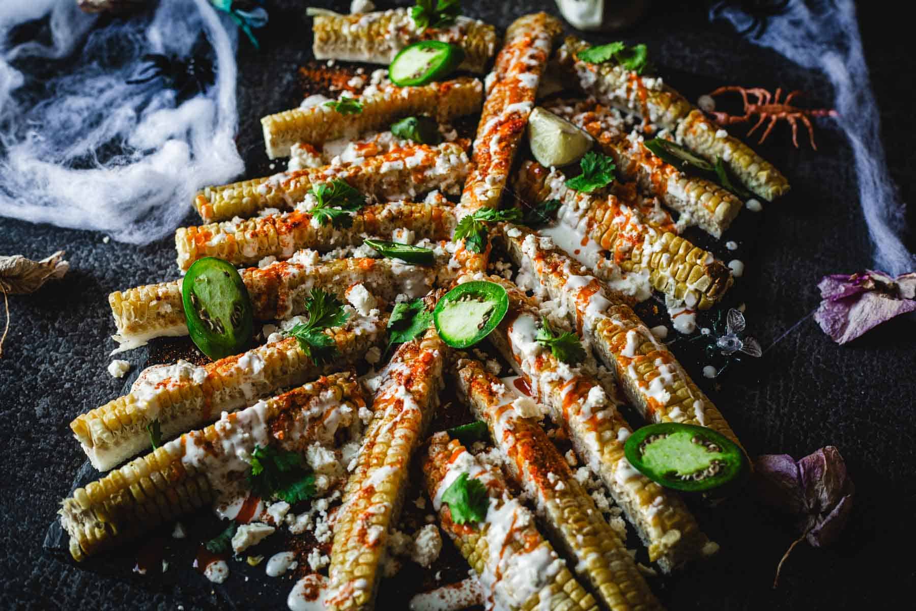 Corn on the cob with cojita cheese and jalapenos.