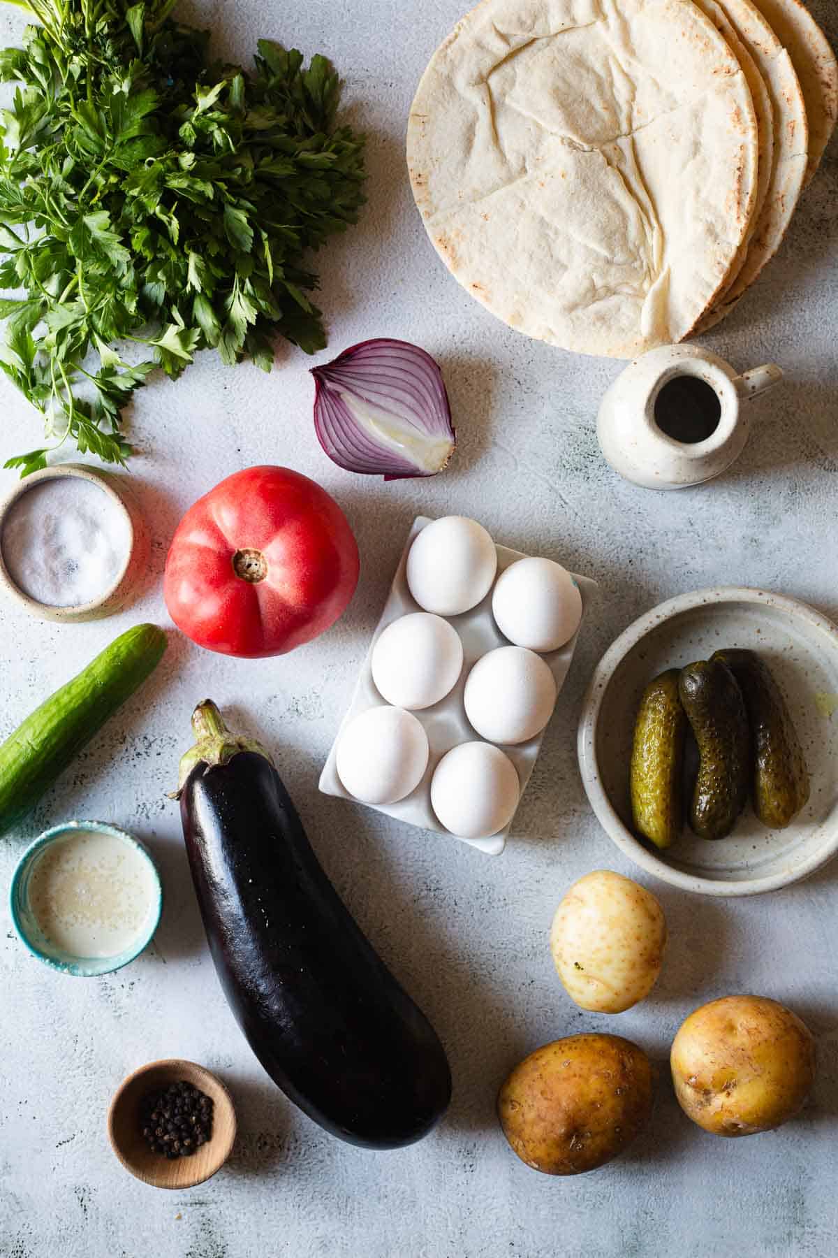 Ingredients for a pita with eggplant, tomatoes, cucumbers and eggs.