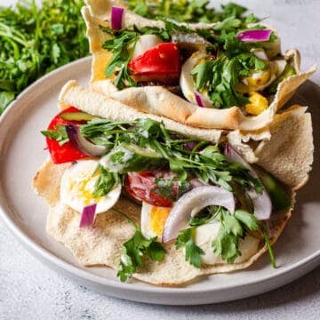 A plate with two pitas on it.