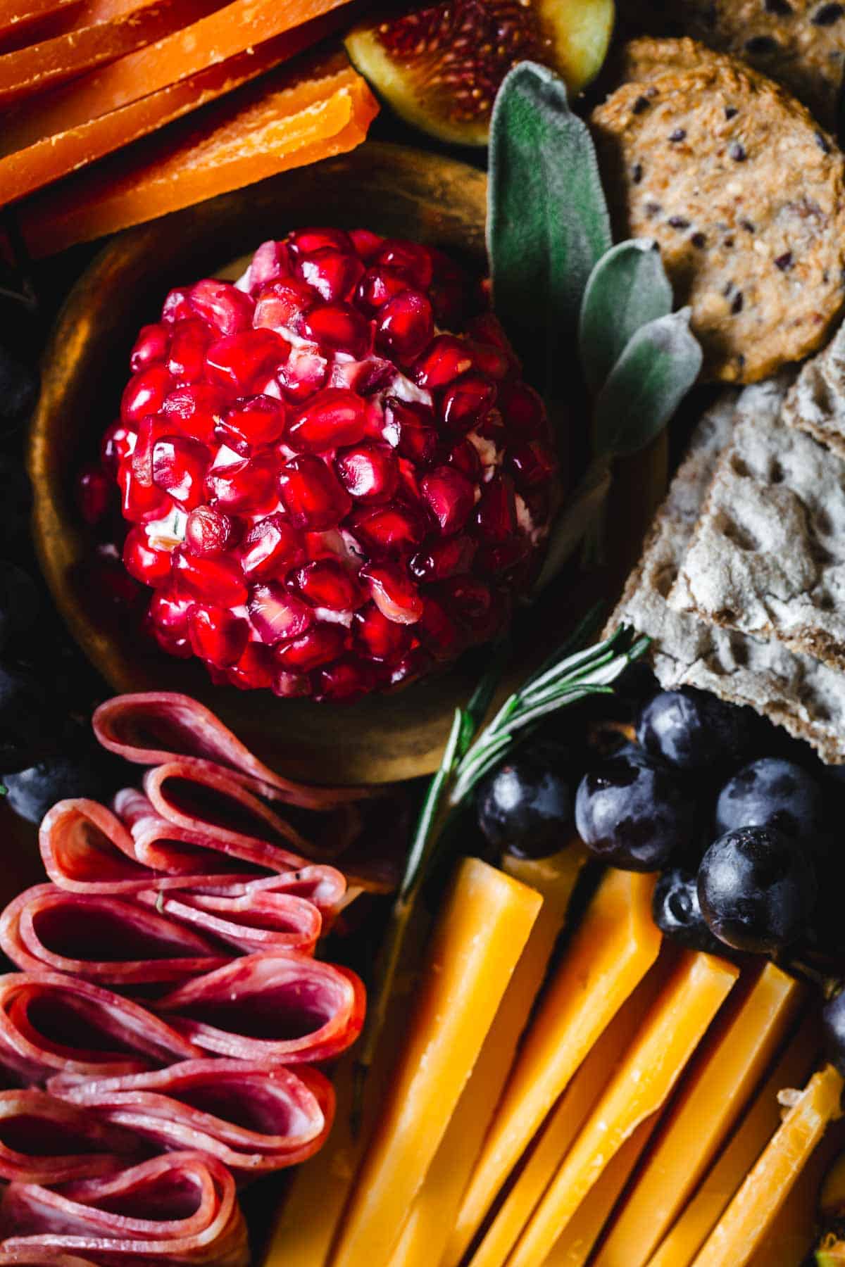 A platter of fruit, cheese and crackers.