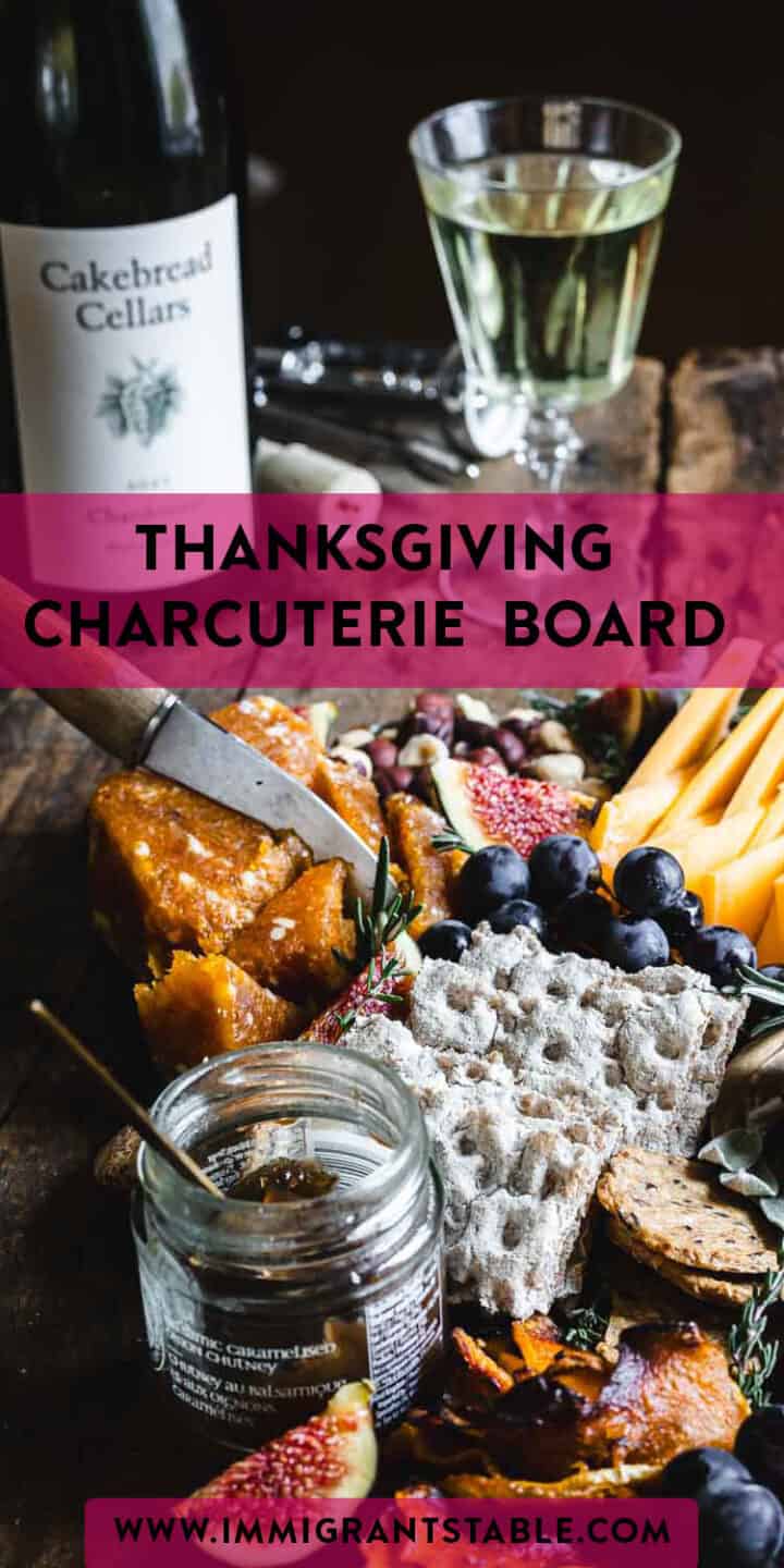 Thanksgiving charcuterie board featuring a delightful assortment of cheese and wine.