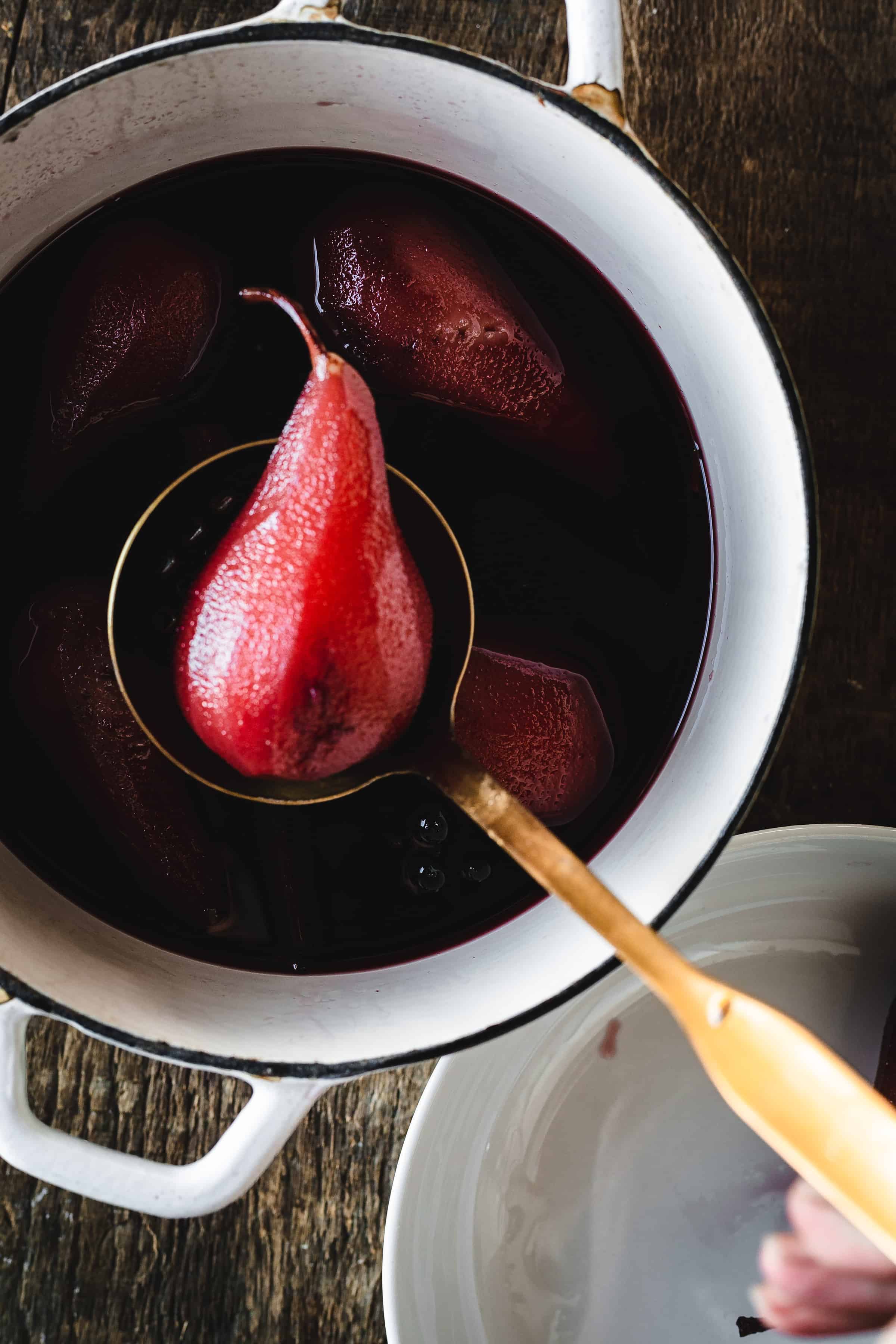 Pears in a pot with a spoon.