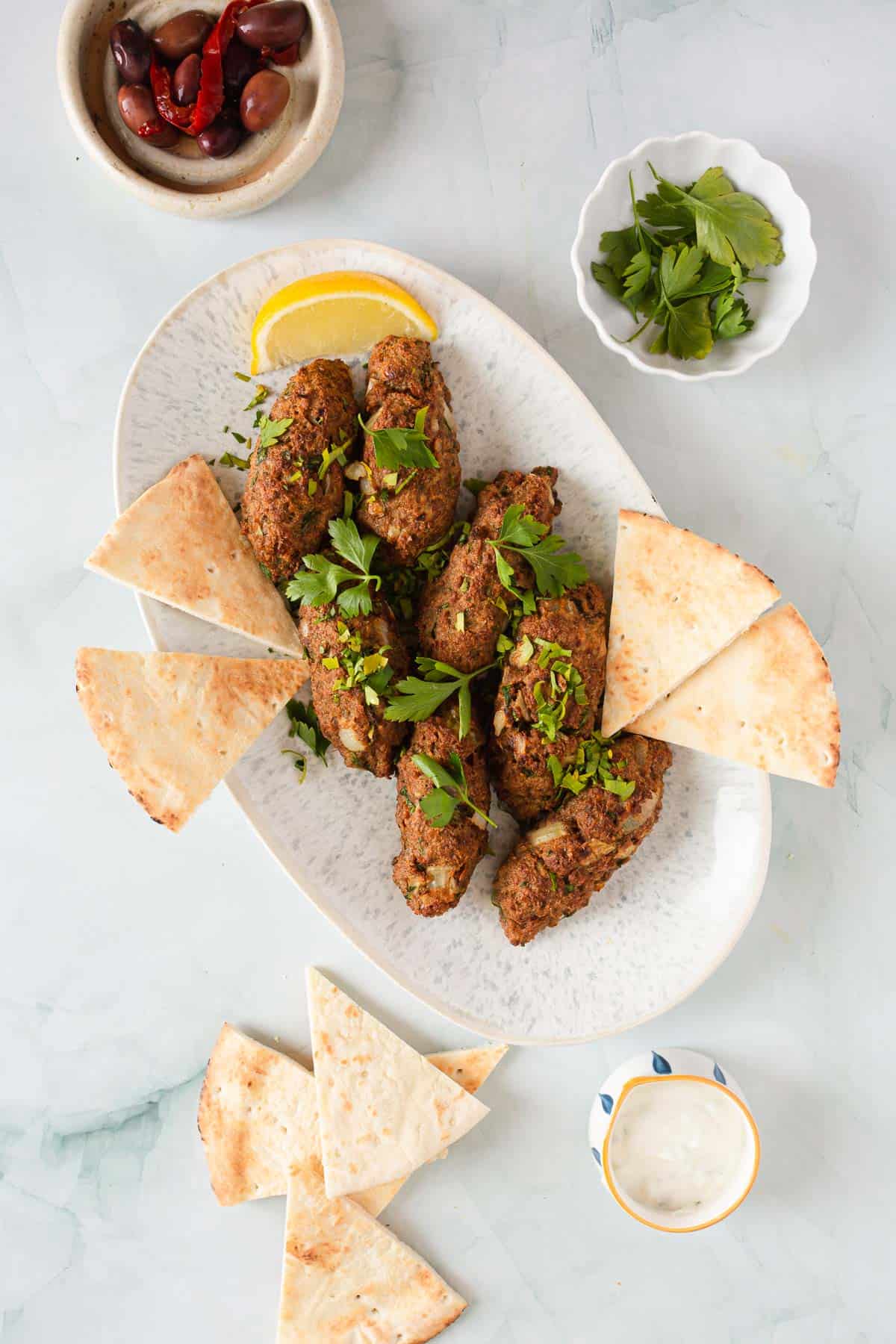 kofta kebabs with tahini sauce and pita bread.