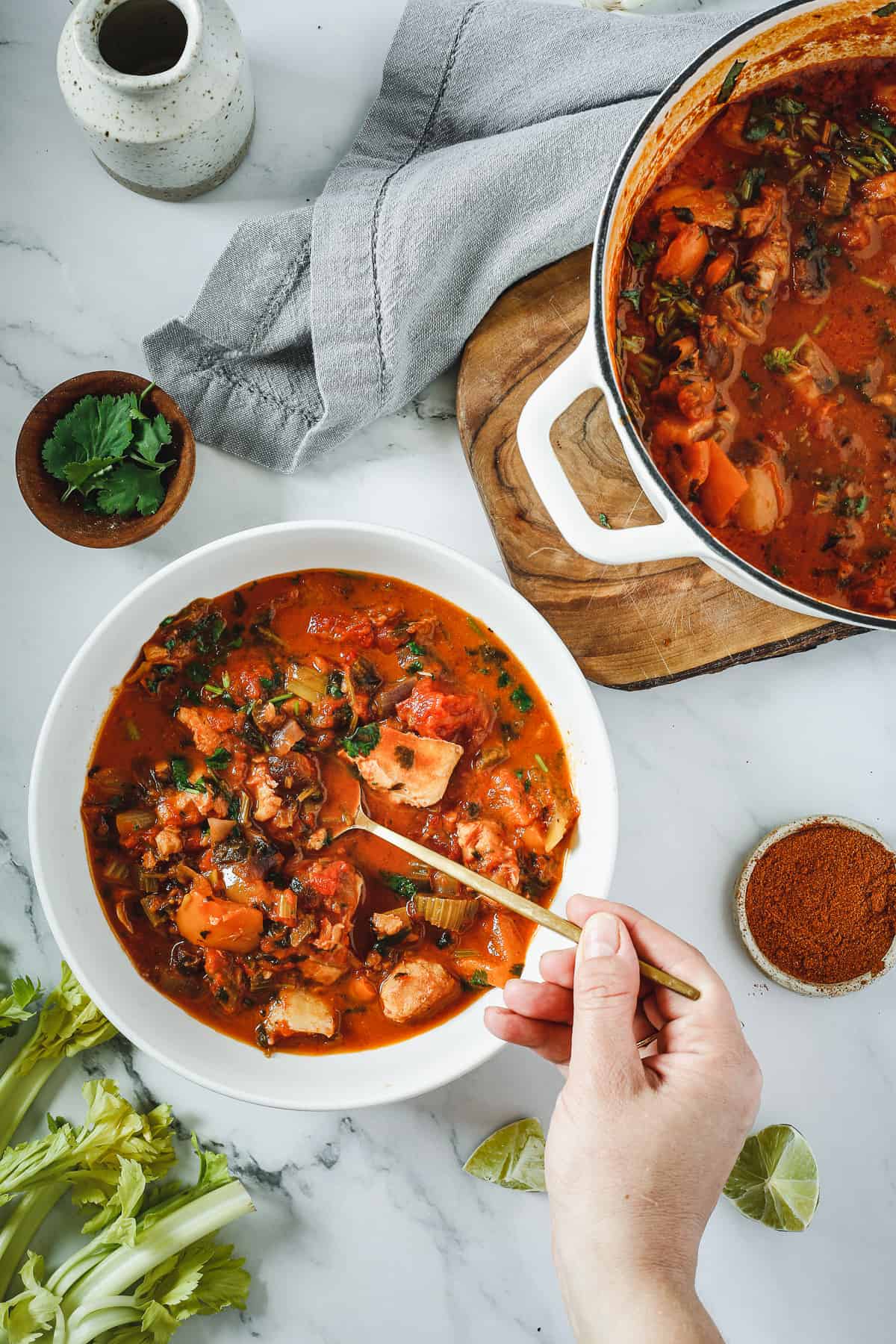 A bowl of stew with a spoon in it.