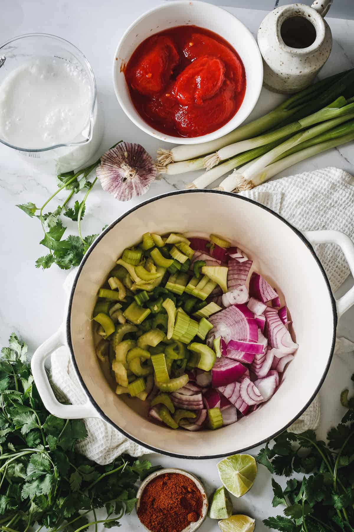 The ingredients for a fish stew are in a bowl on a marble counter.