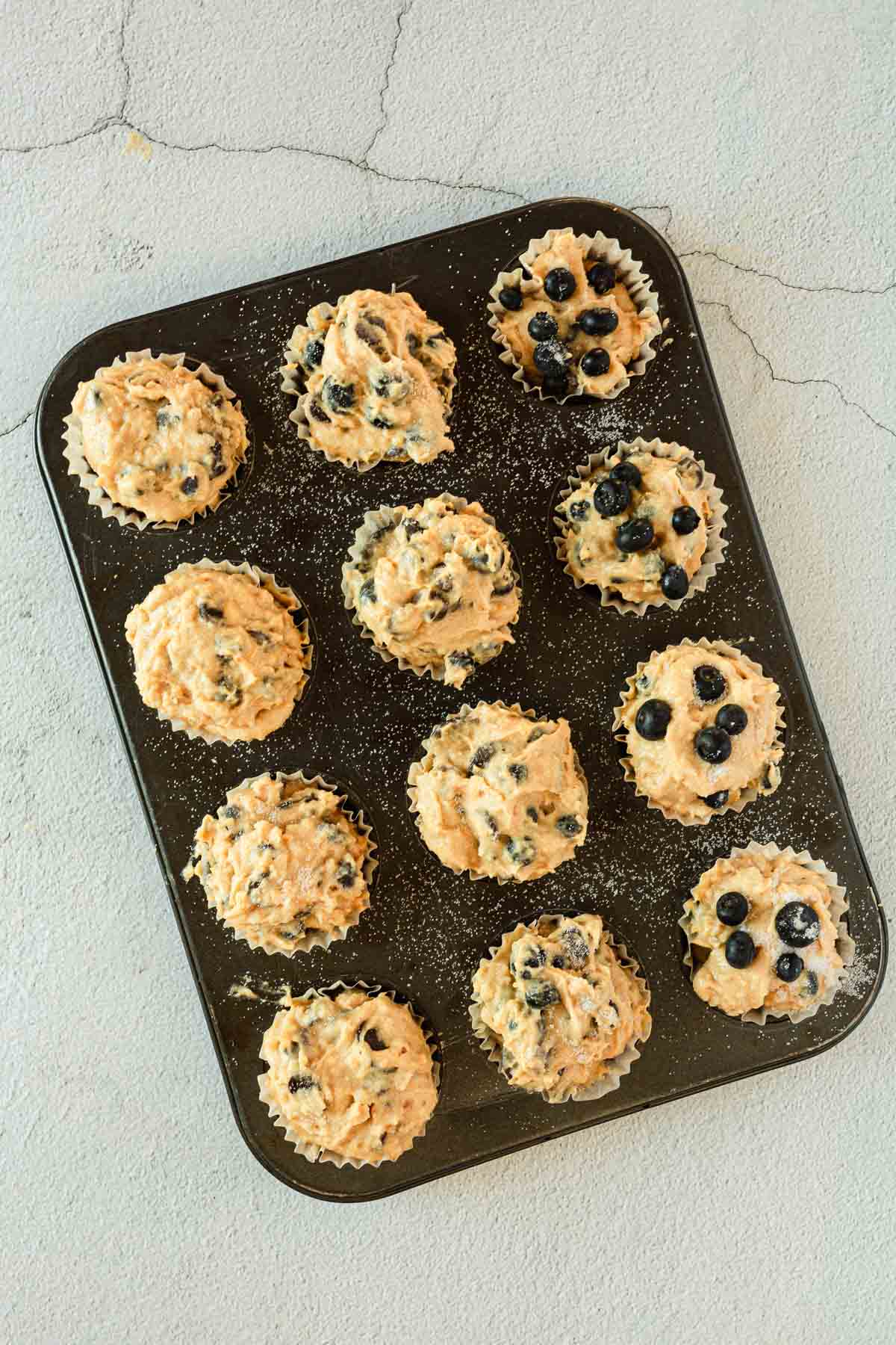 Gluten-free blueberry muffins in a muffin tin.