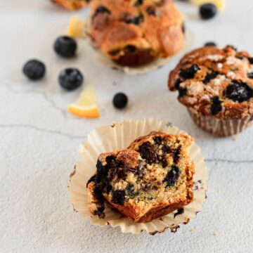 Gluten-free blueberry muffins with lemon slices and blueberries.