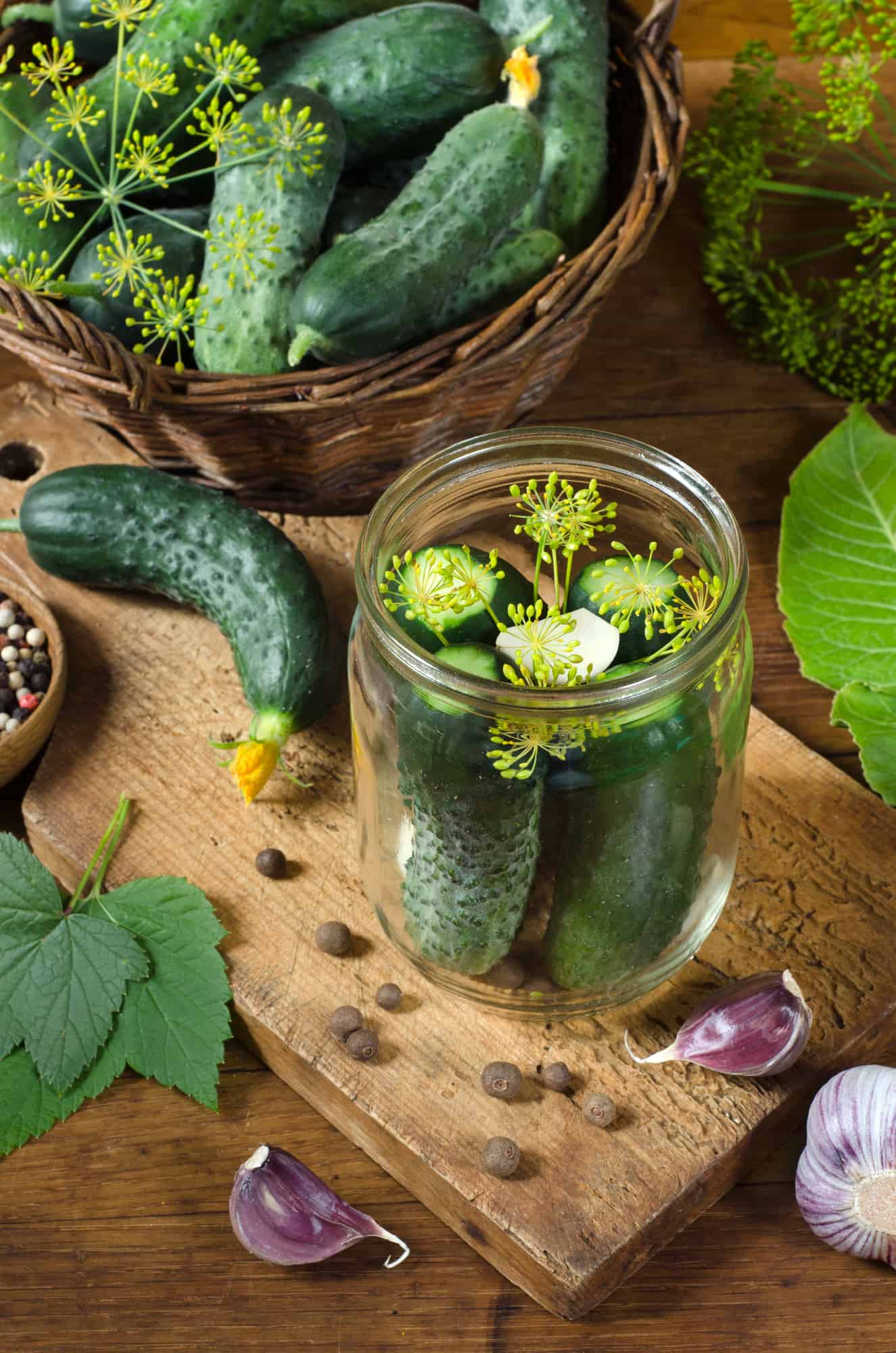 A glass jar with fermented pickles in it.