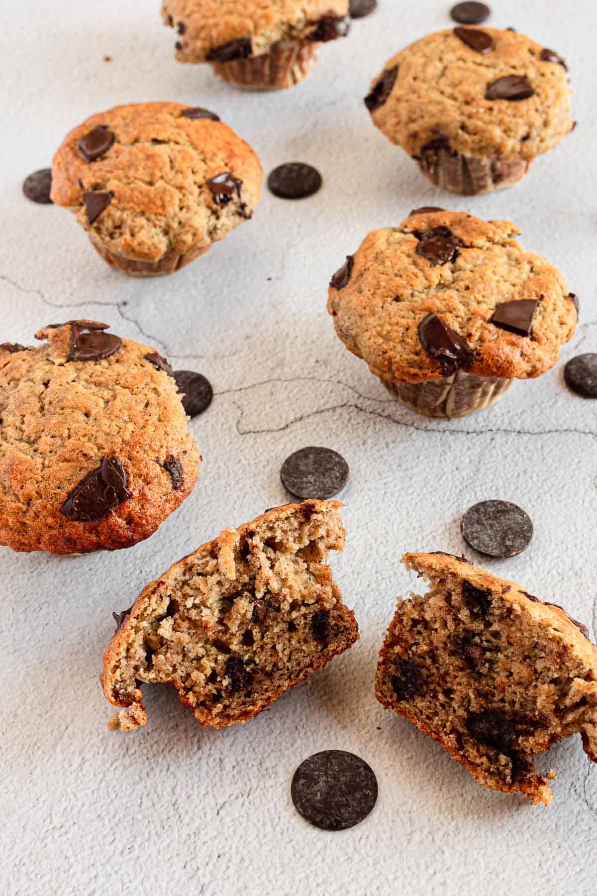 gluten free Chocolate chip muffins with a bite taken out of them.