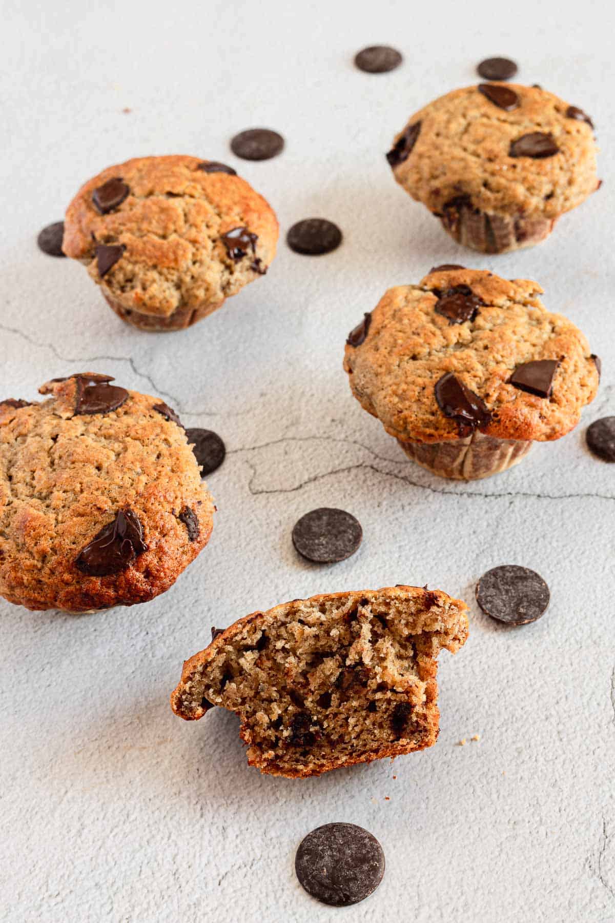 gluten free Chocolate chip muffins with a bite taken out of them.