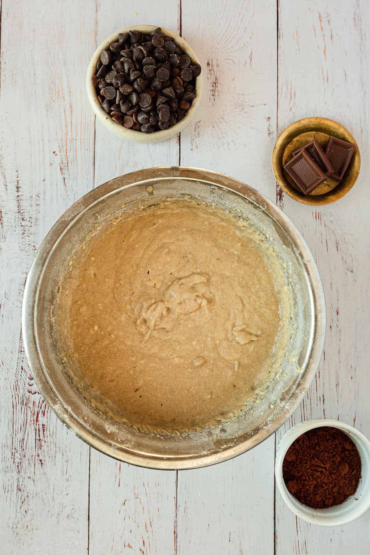 A bowl of batter with chocolate chips and other ingredients.