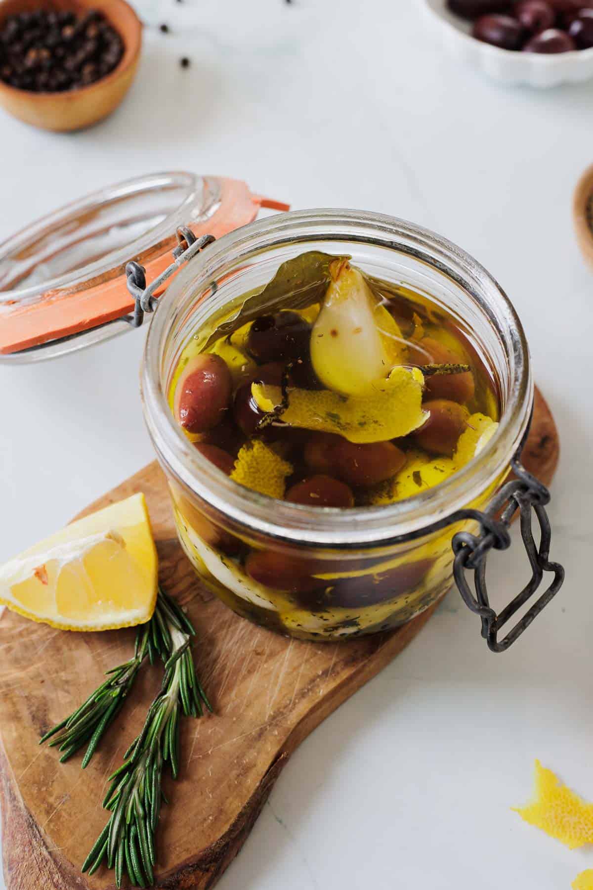 cheese curds in a jar on a wooden cutting board.