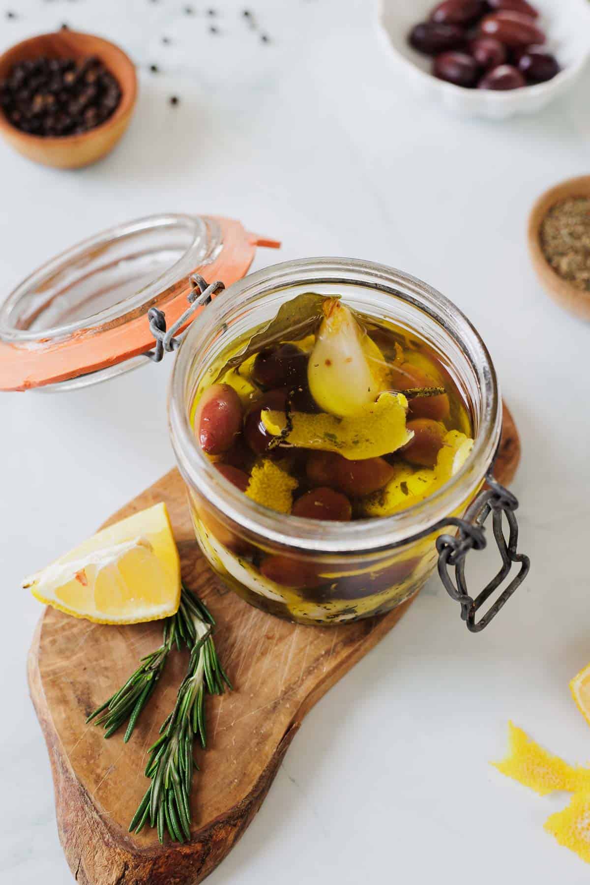 cheese curds in a jar on a wooden cutting board.