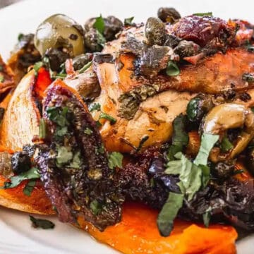 chicken with veggies and fork on white plate