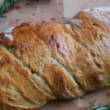 Bread on baking board with rosemary