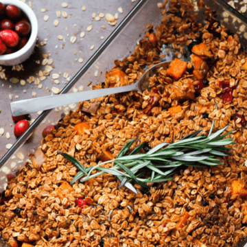 A dish of granola with cranberries and sprigs of rosemary from Mom's recipes.
