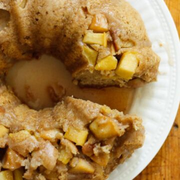A bundt cake on a plate with a bite taken out of it, showcasing one of the prettiest desserts.