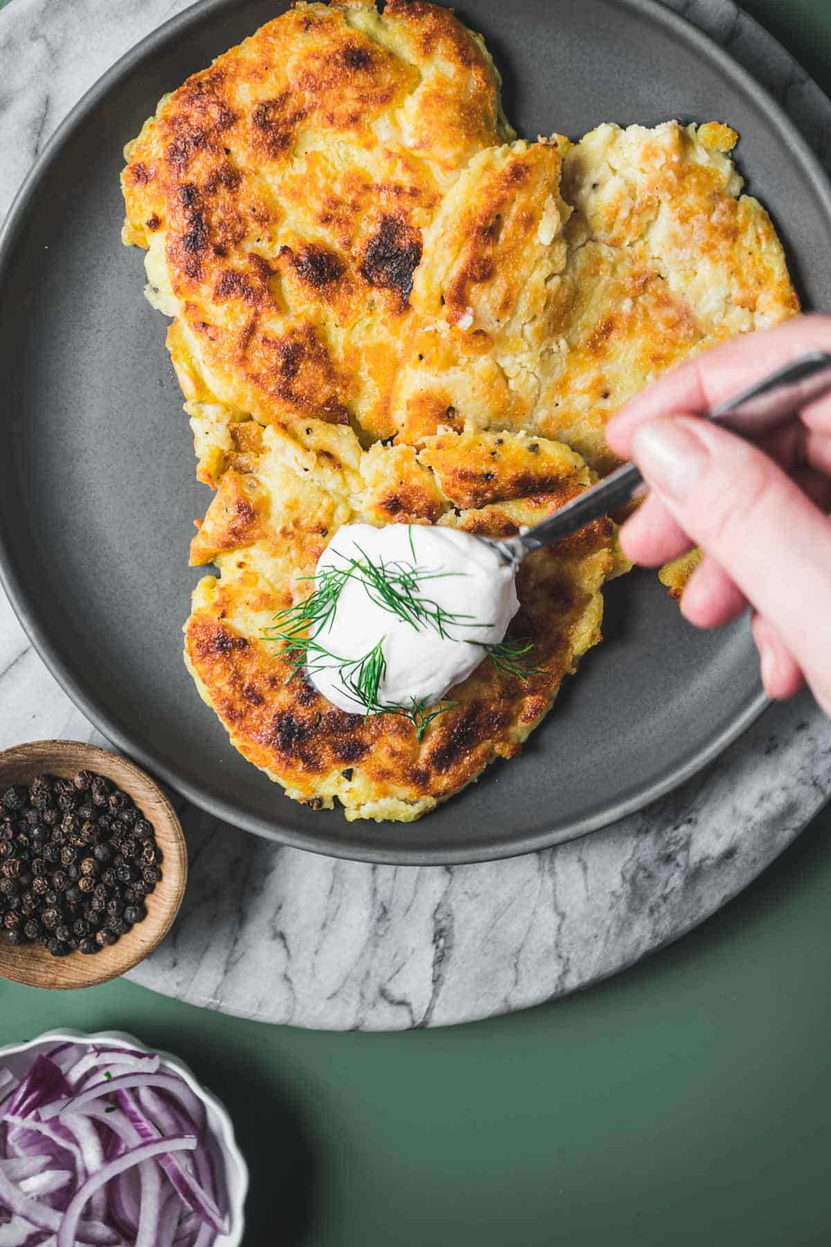 irish boxty with sour cream on a plate.