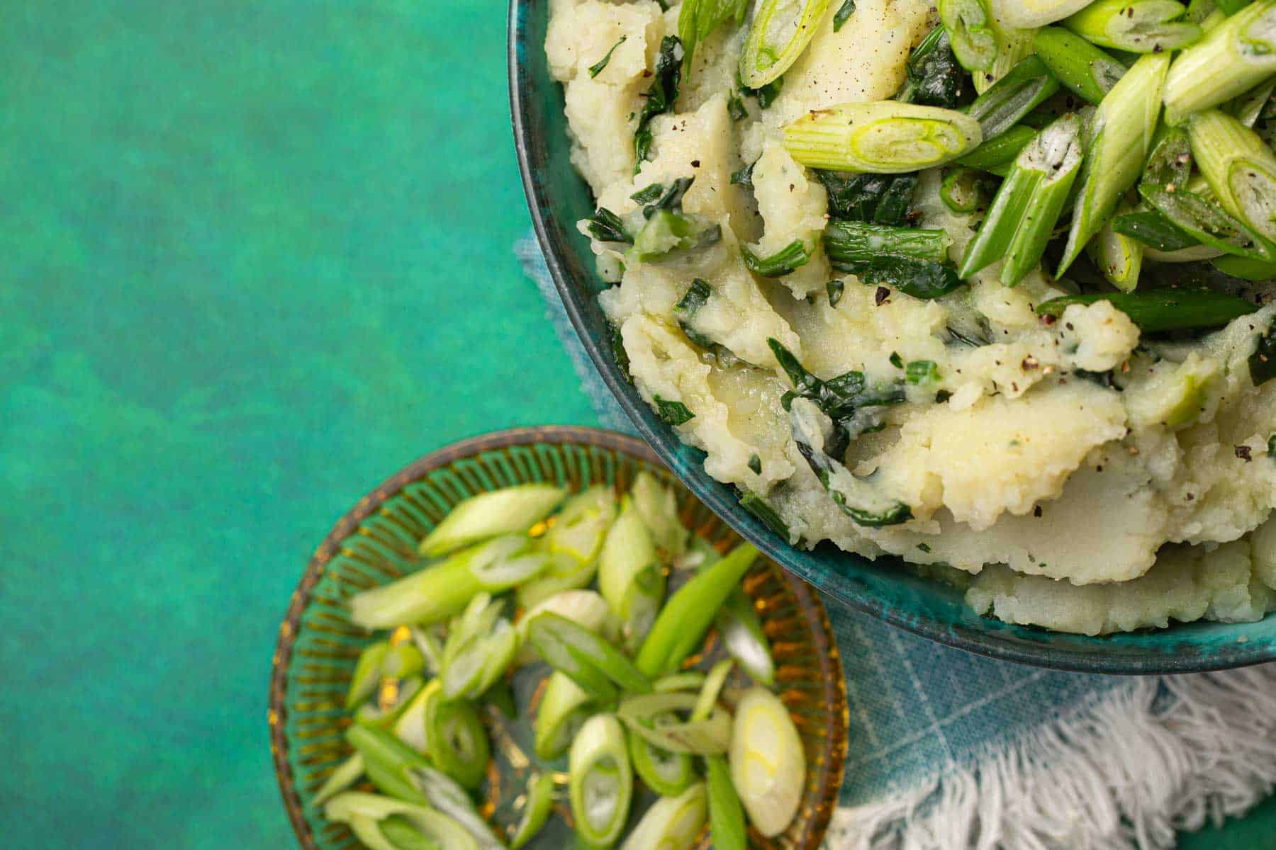 Irish colcannon with scallions in a bowl on a table.