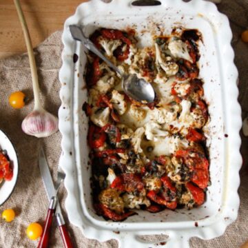 Cauliflower and tomatoes in casserole dish.