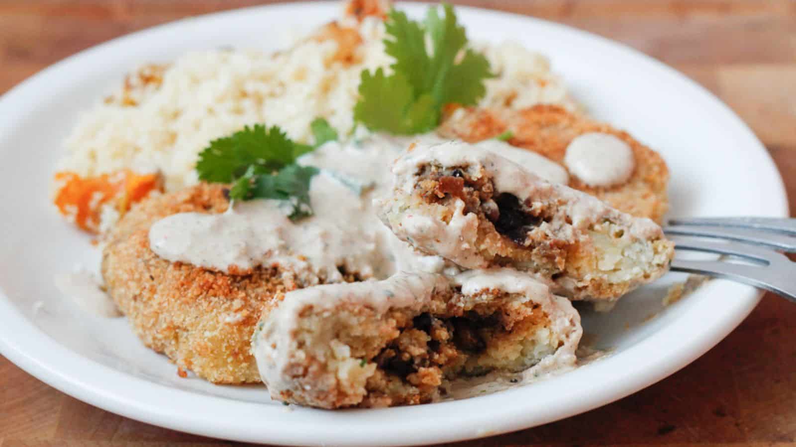 Three patties on a plate with rice.