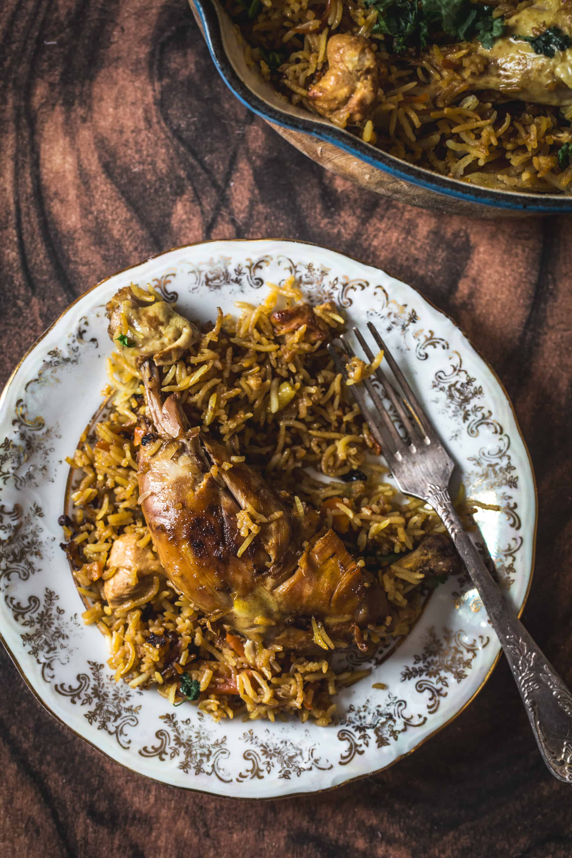 Chicken plov on a plate with a fork.