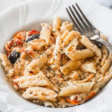 Plate of pasta with feta and fork.