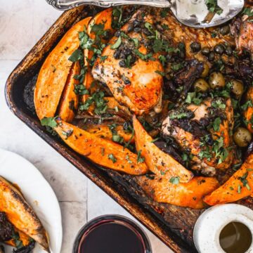 Mom Makes roasted chicken with sweet potatoes and olives on a baking sheet.