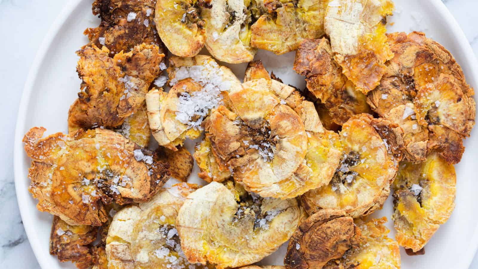 Overhead view of tostones with salt.