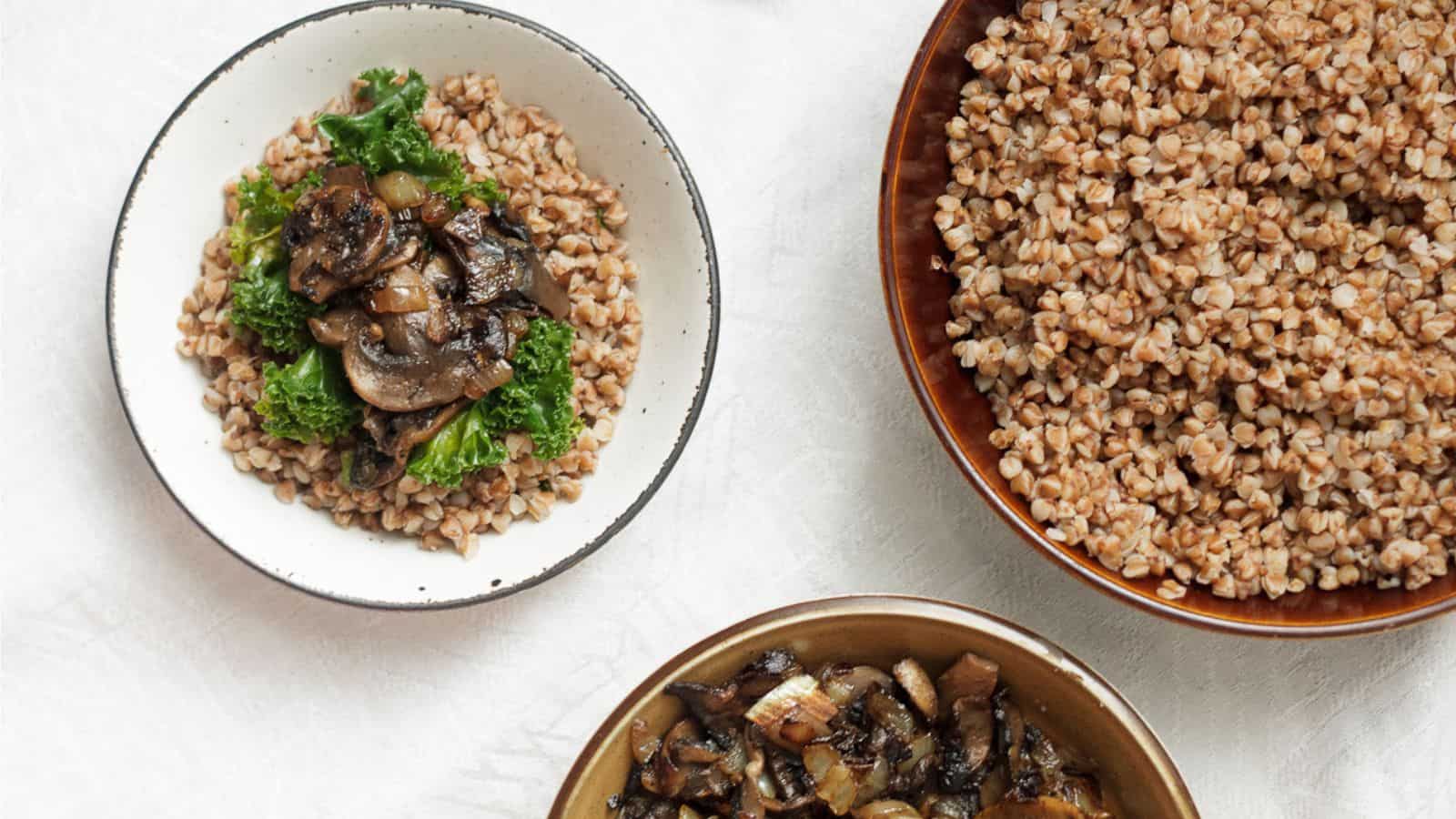 Three bowls of buckwheat kasha with mushrooms and greens.