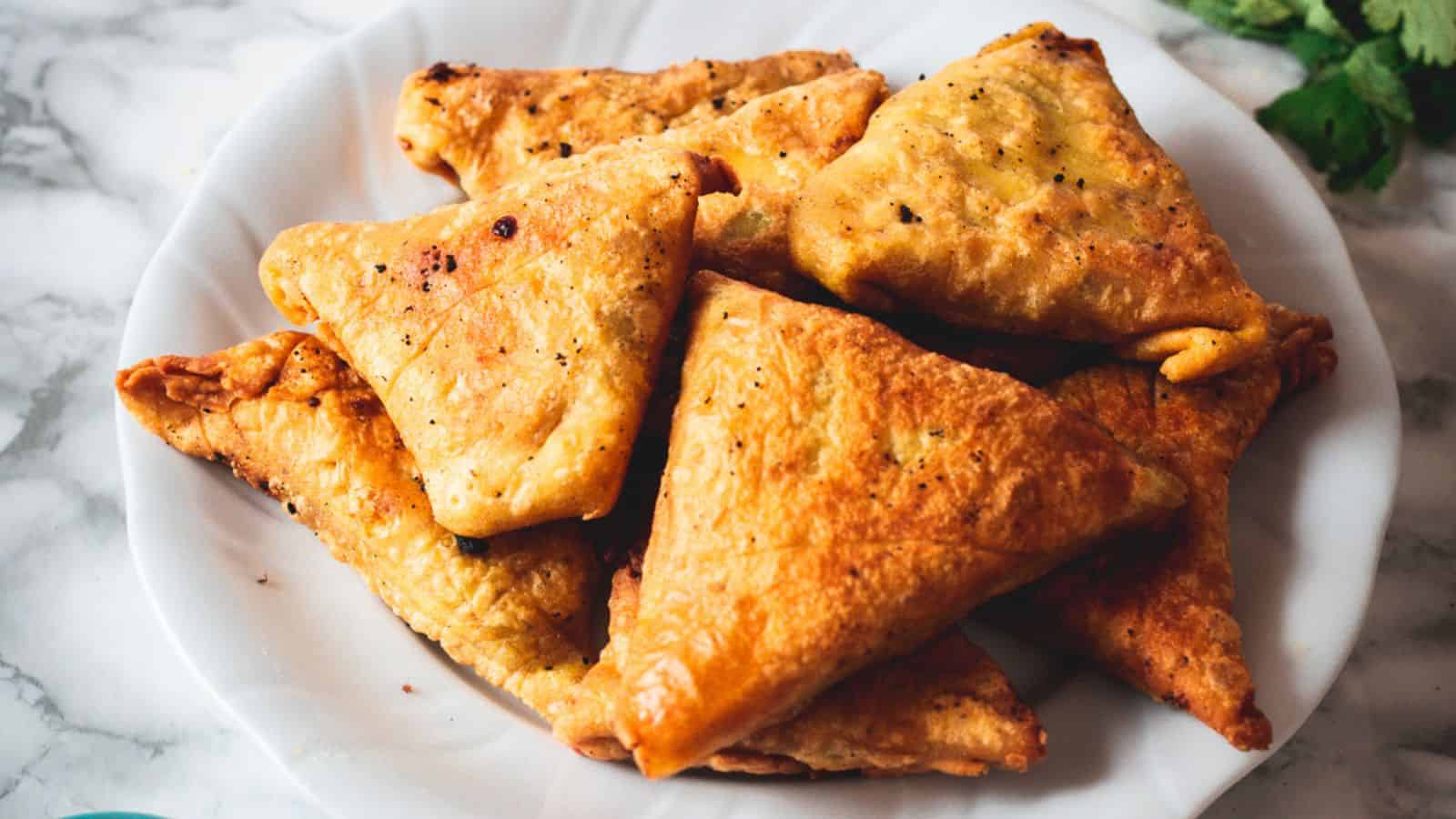 Gluten free samosas on white background.