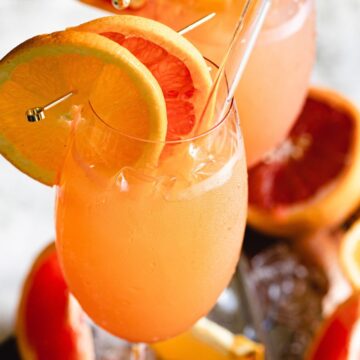 two glasses with citrus garnishes.