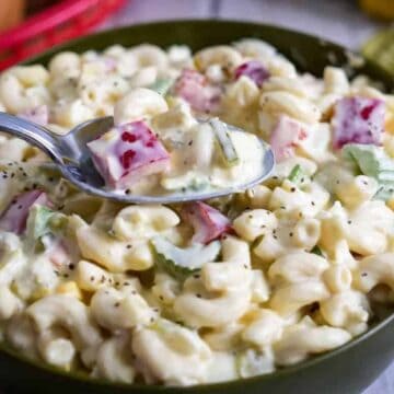 Bowl of pasta salad with spoon.