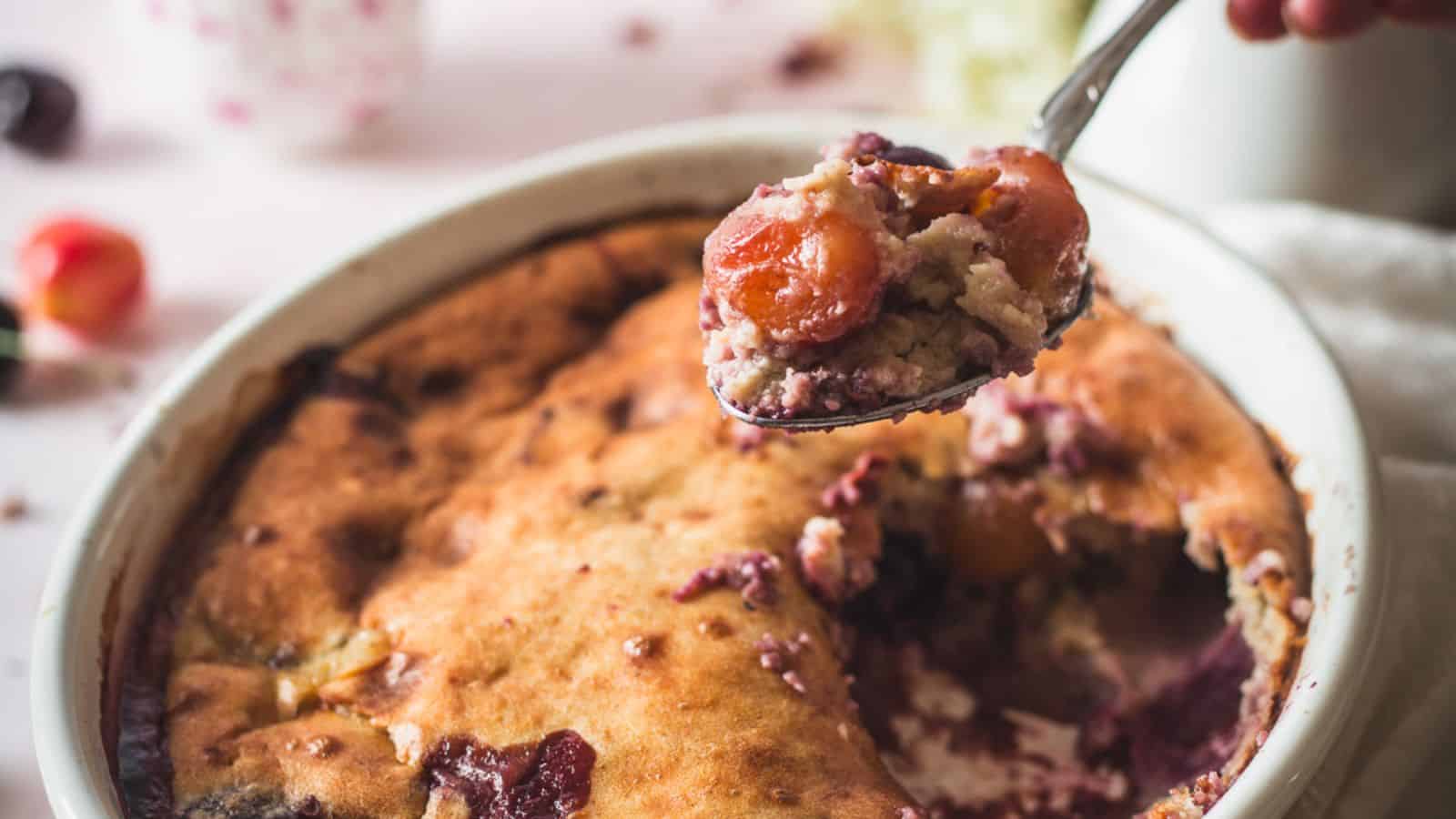 side view of slice of cherry cobbler with ice cream.